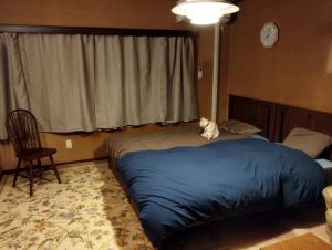 a cat sitting on a bed in a bedroom at Ishinomaki - House - Vacation STAY 16456 in Ishinomaki