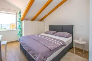 a bedroom with a large bed and a window at House Villa Verdi in Tkon