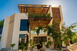 a building with plants on the side of it at Condo Moots 101 with private pool & rooftop yoga in Tulum