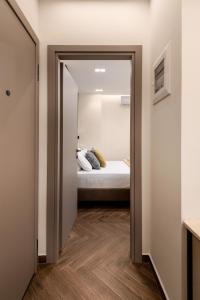 a hallway leading to a bedroom with a bed at LP Luxury Citycenter Apartment in Serres