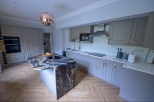 a large kitchen with a large island in the middle at Number 2 in Mountain Ash