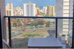 a view of a city from a balcony with a bench at Completo, varanda, 800m da praia! Tranquilidade in João Pessoa