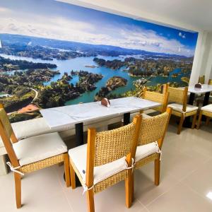 a dining room with a large painting of a river at Maidy Luxury in Medellín