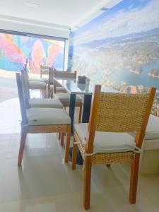 a dining room with chairs and a table with a view at Maidy Luxury in Medellín