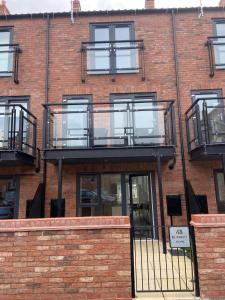 a brick building with balconies on the side of it at Modern 3 Bed Town House Marina Hull in Hull