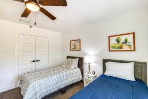 a bedroom with two beds and a ceiling fan at Fire Pit and Grill Lakeside Gun Barrel City Home! in Gun Barrel City