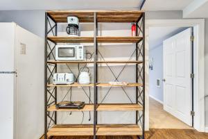 a room with wooden shelving in a kitchen with a microwave at East Stroudsburg Apartment Golf, Hike and Ski! in East Stroudsburg