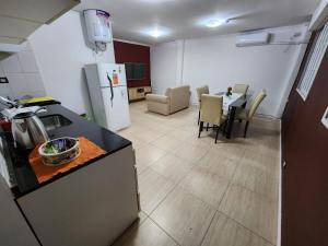 a kitchen and living room with a table and a refrigerator at Departamento “Edificio Manuelita” in Resistencia +7 photos