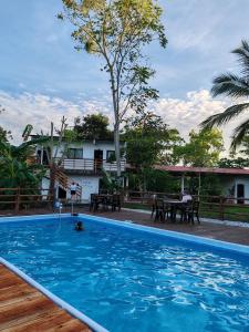 a swimming pool in front of a house at Finca Campestre La Flor in Doradal