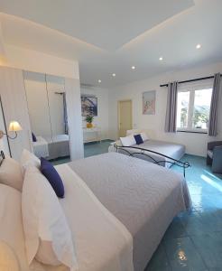 a hotel room with two beds and a couch at Villa Furoris Apartment in Furore