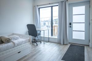 a bedroom with a bed and a desk and a window at Private Unit in the heart of Ottawa, 3 minutes to downtown Ottawa in Ottawa