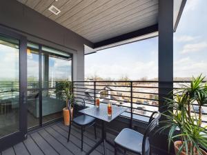a patio with a table and chairs on a balcony at Fox Hollow - 2 New Homes - Downtown Views in Nashville