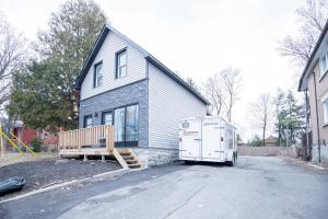 a house with a truck parked in the driveway at Private Unit in the heart of Ottawa, 3 minutes to downtown Ottawa in Ottawa