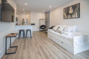 a bedroom with a bed and a kitchen and a table at Private Unit in the heart of Ottawa, 3 minutes to downtown Ottawa in Ottawa