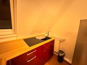 een kleine keuken met een wastafel en een raam bij Cozy Wohnung in Meerbusch in Meerbusch