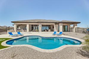 a house with a swimming pool in front of a house at Luxurious Desert Oasis Fireplace and Private Pool! in Apache Junction