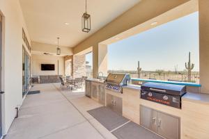 a large living room with a kitchen and a patio at Luxurious Desert Oasis Fireplace and Private Pool! in Apache Junction