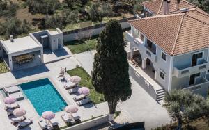 an aerial view of a house with a swimming pool at Villa Olympia in Pandokrátor