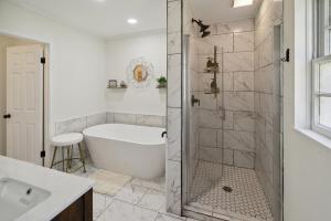 a white bathroom with a tub and a shower at Urban Farmhouse with a Modernism Twist! home in Moultrie