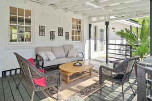 a porch with a couch and chairs and a table at Urban Farmhouse with a Modernism Twist! home in Moultrie