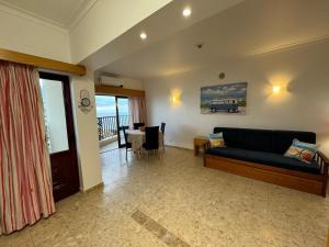 a living room with a couch and a dining room at Sofiamarholidays - Casa Praia Mar in Portimão