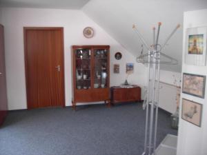 a room with a door and a cabinet and a staircase at Ferienhaus in Obernsees mit Garten, Terrasse und Grill in Mistelgau