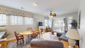 a living room with a table and a couch at Litchfield Lakeside Oasis 2BR Villa near the Beach in Pawleys Island