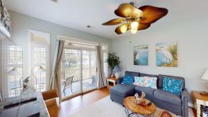 a living room with a couch and a ceiling fan at Litchfield Lakeside Oasis 2BR Villa near the Beach in Pawleys Island