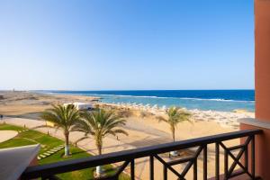 a view of a beach with palm trees and the ocean at Oyster Bay Beach Suites in Abu Dabbab