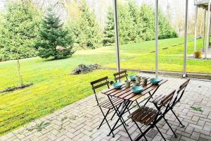 a wooden table and chairs on a patio at Spacious one bedroom with garden&balcony in Pulvermühle