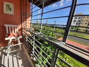 a balcony with a bench and a view of plants at Comfortable Apartament in Los Paredones