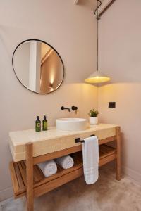 a bathroom with a sink and a mirror at ANTIPODA HOTEL Boutique in Medellín
