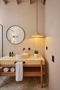 a bathroom with a sink and a mirror at ANTIPODA HOTEL Boutique in Medellín