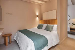 a bedroom with a large bed with a wooden headboard at ANTIPODA HOTEL Boutique in Medellín