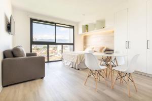 a bedroom with a bed and a table and chairs at Brand new 1 bed loft with spectacular city view in El Empalme