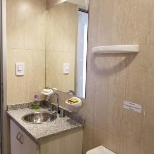a bathroom with a sink and a mirror at DELFINA suites 3A in La Rioja +15 photos