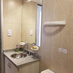 a bathroom with a sink and a mirror at DELFINA suites 3A in La Rioja