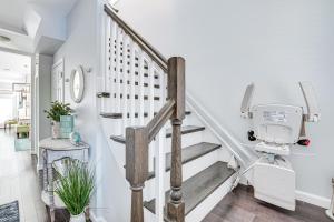 a white stairwell with a white stair case at Long Branch Beach House with Private Hot Tub! in Long Branch