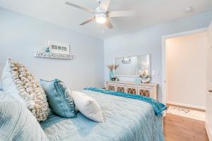 a bedroom with a bed and a ceiling fan at Long Branch Beach House with Private Hot Tub! in Long Branch
