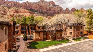 an aerial view of a building with a mountain in the background at LaFave Luxury Rentals at Zion in Springdale