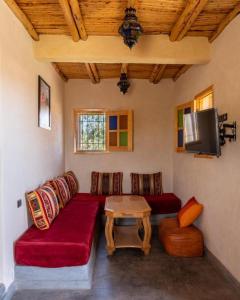 ein Wohnzimmer mit einem Sofa und einem Tisch in der Unterkunft Villa Dar Sarah (private pool and hammam, piscine privée et hammam) in Agadir