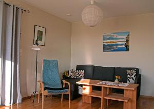 a living room with a couch and a table at Långänge Bed & Breakfast in Tandsbyn