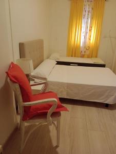 a bedroom with a bed and a chair and a table at Aurora Room with Private Bathroom in Alicante