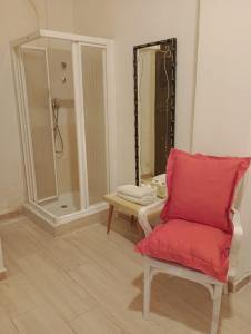 a bathroom with a red chair and a shower at Aurora Room with Private Bathroom in Alicante