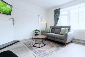 a living room with a couch and a table at High view house, 3 bed flat. in Walton-on-the-Naze