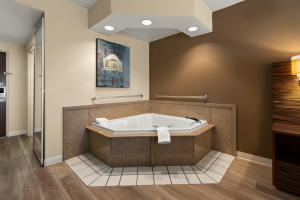 A bathroom at Ramada by Wyndham Harrisburg/Hershey Area