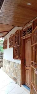 an entrance to a house with a wooden door at Paysage Cache in Estelí