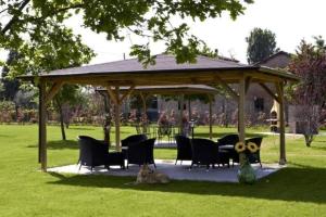 a gazebo with chairs and a table in a park at Appartement in Scandiano mit Privatem Parkplatz in Scandiano