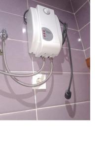 a hair dryer hanging on a wall in a bathroom at Apartamento T1 in Praia