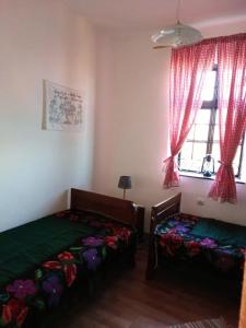 a bedroom with two beds and a window at Country house pivnica Milic Rogljevo in Rogljevo +3 photos